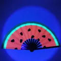 Glow-in-the-dark folding fan with watermelon seed pattern and neon green edges - Watermelon UV Glow A33