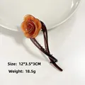 Amber brown rose-shaped acetate hair clip with layered petals and 12cm length - Caramel color