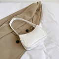 Minimalist white underarm bag in smooth PU leather styled on a khaki blazer jacket - White