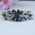Vintage bow flower hair clip with deep blue rhinestones and metallic finish - Charlotte