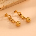 Detailed close-up of gold chunky chain earrings with polished ball pendants on stone - Bead Earrings (G115) / Gold
