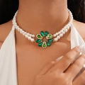 Detail of double-layer pearl necklace with emerald green gemstone flower pendant on neck - Necklace / Green