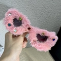 Pink plush cat eye sunglasses with colorful rhinestones held in hand for fashion - Pink Plush With Rhinestones