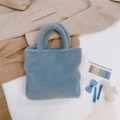 Close-up of the plush light blue tote bag with soft faux fur texture and sturdy handles - Light Blue