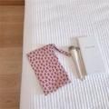 Close-up of a pink butterfly pattern cotton makeup storage bag with a handy wrist strap - Pink Background Heart