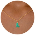 Golden necklace featuring a turquoise coral branch pendant worn on a female neck - Green Antler Necklace