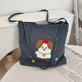Detailed view of cartoon puppy embroidery on striped navy canvas tote bag with PUPPY LAND text - Red Riding Hood Dog