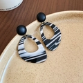 Macro shot of resin drop earrings with black and white marble pattern on a ceramic plate - 36# Silver Earring Post-Black-White (Marble Grain)