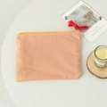 Detailansicht der orange karierten Stofftasche mit gelbem Reißverschluss und roter Quaste - Oranges Karo