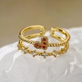 Anillo corona corazón dorado con circón naranja y detalles blancos en papel blanco - Oro Naranja Corazón Circonita