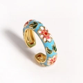 Detailed macro view of light blue enamel floral ring with gold finish and open band - Blue