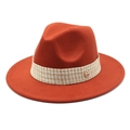 Detail of rust red wool fedora hat with beige braided band and golden M logo charm - Brick Red