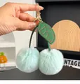 Mint green plush cherry keychain with soft rabbit fur balls and golden metal hardware - Fresh Green
