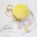 Detail view of resin letter P keychain with yellow pompom and size measurements - Letter P