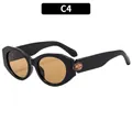 Gafas de sol ovaladas negras modernas con lentes de color ámbar y detalles en patillas C4 - Montura Negra Lentes de Té