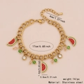 Goldenes Edelstahlarmband mit Wassermelonen-Anhänger, grünen Perlen und Kristalldetails - Wassermelone Armband