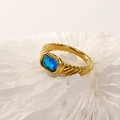 Macro shot of 18k gold plated ring featuring a blue rectangular gemstone and ribbed texture - Gold Blue Zirconia