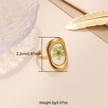 Detail of gold open ring featuring a green dried flower in a clear resin setting - Gold - Irregular Green Dried Flower