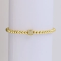 Elastic gold bead bracelet featuring a square pendant set with four sparkling crystals - Letter I