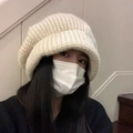 Oversized cream knitted beanie for women featuring a cozy face-slimming slouchy design - Off White