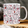 Close-up of white ceramic mug with cute spooky ghosts and pink Valentine hearts on wood - SP-R Style