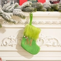 Green knit Christmas stocking with plush cuff and gold embroidered M on fireplace - Letter M