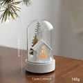 Christmas glass jar light with glowing white wooden house and festive silver trees - White House