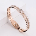 Rose gold zigzag fashion bracelet with pave set cubic zirconia crystals on white background - Rose Gold