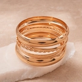 Detailed macro view of 8-piece gold geometric bracelets with varied textures and shiny finish - Gold (8-Piece Set)