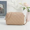 Beige quilted crossbody bag with wide strap and gold hardware on minimalist background - Apricot