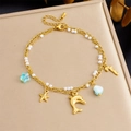 Detail of gold-plated double-layer anklet with shell, dolphin and starfish charms - Dolphin Starfish Double Layer Style (B1610)