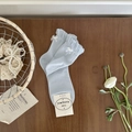 Light blue mid-calf socks featuring delicate white bows and ruffled lettuce edge trims - One Size / Sea Salt Blue