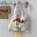 Detail of canvas tote bag featuring cute cartoon duck illustration and plush 3D duck feet - Beige (With Cloud Pendant)
