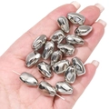 Close-up of irregular silver CCB star beads for DIY jewelry making held in hand - Faceted 3D Bead 10x15mm (10pcs/pack)