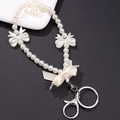 White faux pearl phone charm strap featuring elegant ribbon bows and a silver lobster clasp - K490 Bowknot Keychain