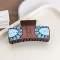 Brown leather-textured shark hair claw clip with blue floral pattern and text - Blue Flower