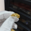 Exquisite gold-plated open ring with intricate textures held in a gloved hand display - Embossed Texture Style (J24589)
