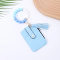 Close-up of a blue silicone bead bracelet with a matching leather tassel and card holder - Blue