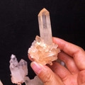 Natural orange phantom quartz crystal cluster specimen held by hand for display - Approx. 100-150g