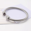 Silver twisted cable cuff bracelet featuring deep red round zircon stone accents - July/Deep Red