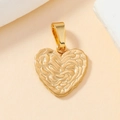 Macro shot of a golden heart pendant with a unique wavy texture on a minimalist base - 100-Gold Ripple Textured Heart Pendant