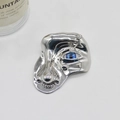 Artistic surrealist silver metal face brooch with blue eye and sparkling crystal details - Classic / Silver