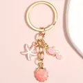 Portachiavi stella marina e cavalluccio marino con paillettes rosa e ciondolo conchiglia - Stella marina Cavalluccio marino Rosa Bianco