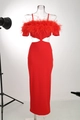 Detail of red off-shoulder dress featuring lush feather trim and side cut-outs - S / Red