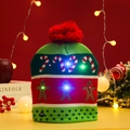 Detail of LED knitted Christmas hat featuring gingerbread pattern and light switch button - Gingerbread Man/Red Green White
