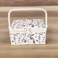 Detail of fabric sewing basket with vintage machine prints on a light wooden table - A Style - White Sewing (White Edge)