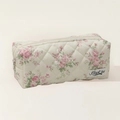 Close-up of quilted floral beige pencil case with pink flower patterns and zipper detail - Pink Flower