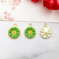 Three pieces of green daisy flower alloy pendants with yellow centers on marble surface - 13x16mm / Green