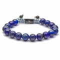 Macro detail of 10mm tiger eye beads and woven cord with engraved metal slider charm - Natural Lapis Lazuli Bracelet