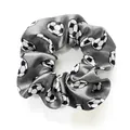 Macro view of grey satin scrunchie featuring a detailed black and white football pattern - Gray